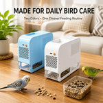 The Electric Bird Seed Separator in white and in blue on a table, with budgies and a bowl of seed.